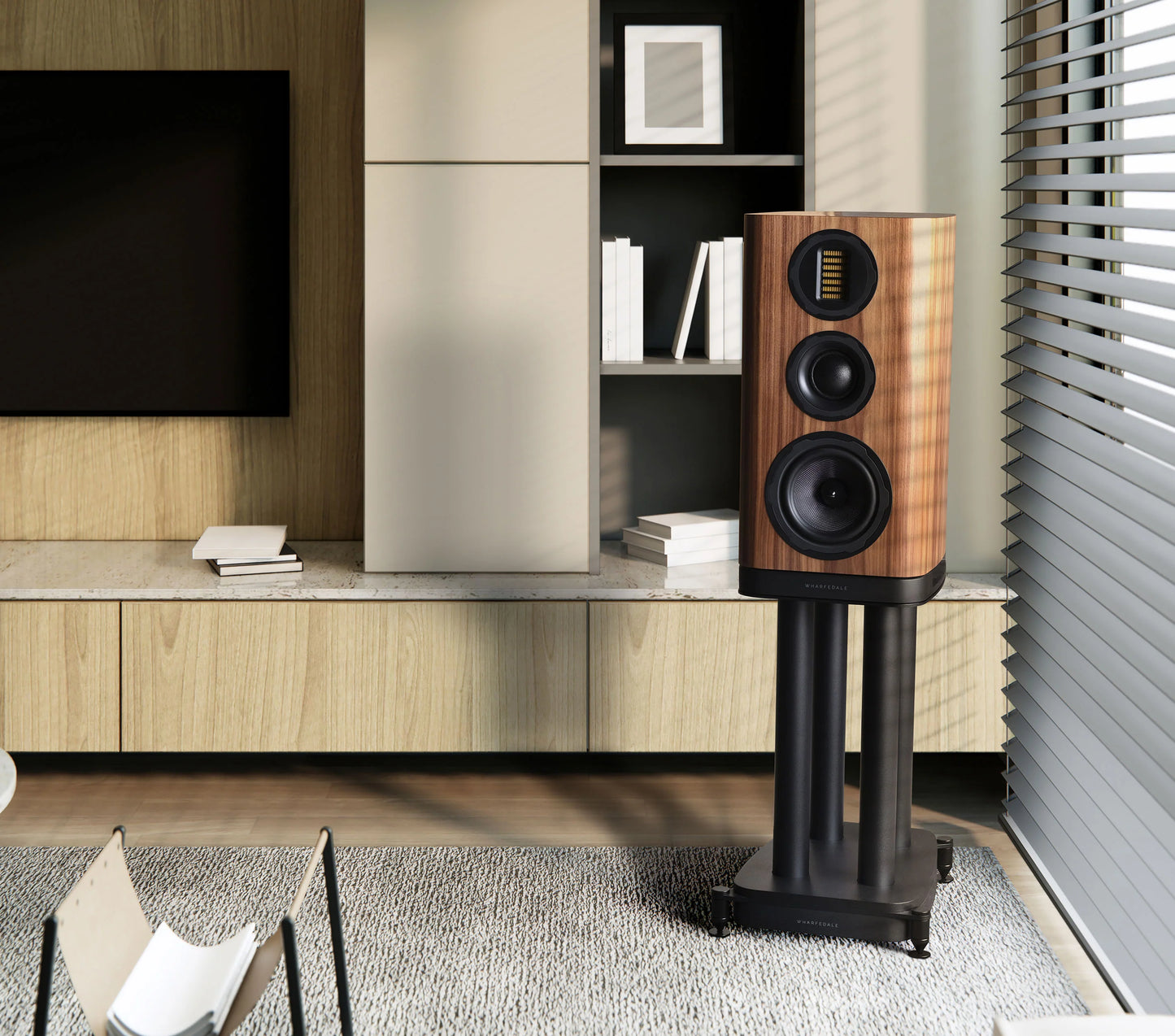 Wooden speaker on a stand in a modern living room setting.