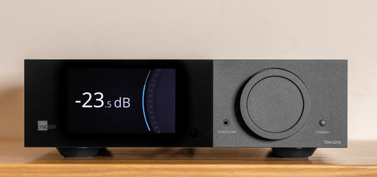 Front view of the Lyngdorf TDAI-2210 digital streaming amplifier featuring a color touchscreen display and signature volume wheel.